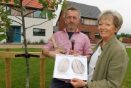 Stone carver Teucer Wilson and Maggie Abel of Abel Homes with the plans for a giant walnut sculpture to be sited in Mattishall sm