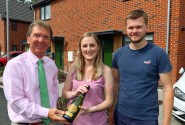 Tony Abel left of Abel Homes with Sian Smith and Alex Williams outside their new home in Swaffham sm