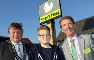 Cllr Colin Houghton Elliot Clark and Tony Abel in front of the new village sign at Swans Nest in Swaffham sm