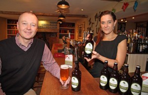 Marcus Sanders of Abel Homes and Marta Sztorc of the White Hart in Hingham toast the success of The Hops Bitter