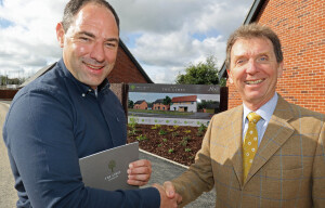 Housebuyer Phil Royle left is congratulated by Tony Abel on being the first to buy a new home at The Limes in Little Melton sm