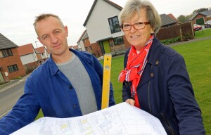 Stone carver Teucer Wilson and Maggie Abel of Abel Homes survey the site at Hingham where the new public artwork will be installed sm