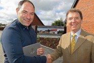 Housebuyer Phil Royle left is congratulated by Tony Abel on being the first to buy a new home at The Limes in Little Melton sm