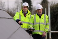 Paul Legrice left and Alan Read of Abel Homes perform the traditional topping out ceremony at Little Melton sm