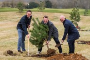 from left Paul LeGrice James Stanley and Mark Burton plant a Scots pine tree at Royal Norwich