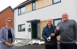 Darren Mckenna right and his father Thomas receive the keys to Mr Mckennas new home from Abel Homes sales manager Clare Cornish sm