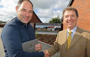 Housebuyer Phil Royle left is congratulated by Tony Abel on being the first to buy a new home at The Limes in Little Melton sm