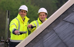 Paul LeGrice left and Alan Hawkins from Abel Homes top out the first of the new homes at Gressenhall sm