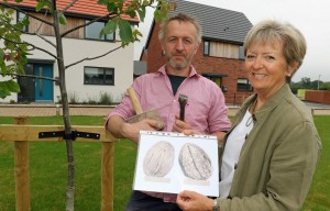 Stone carver Teucer Wilson and Maggie Abel of Abel Homes with the plans for a giant walnut sculpture to be sited in Mattishall sm