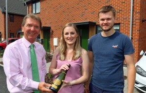 Tony Abel left of Abel Homes with Sian Smith and Alex Williams outside their new home in Swaffham sm