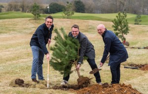 from left Paul LeGrice James Stanley and Mark Burton plant a Scots pine tree at Royal Norwich